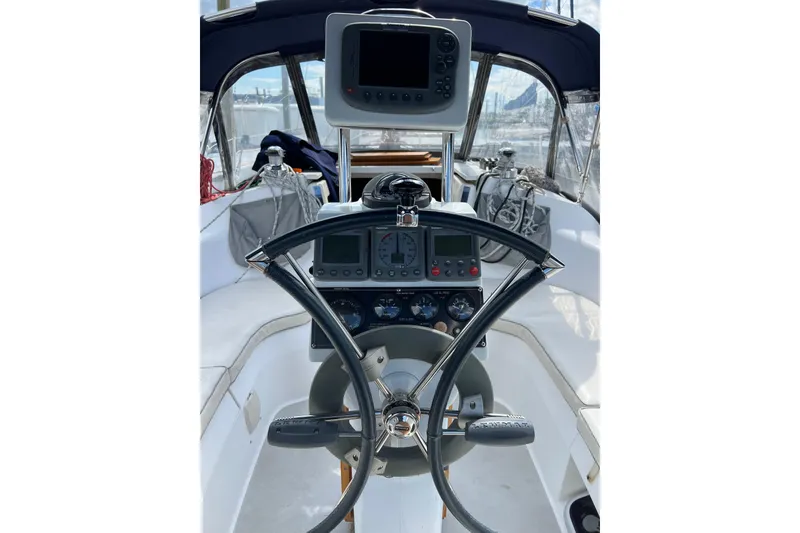 Slide: The Image of Cockpit of 2007 Catalina 309 sailboat with navigation instruments and steering wheel. - 11