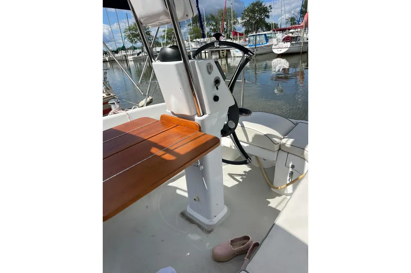 Slide: The Image of Cockpit of 2007 Catalina 309 sailboat with wooden table and steering wheel. - 13