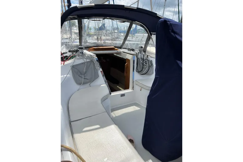 Slide: The Image of 2007 Catalina 309 sailboat cockpit with seating and covered helm, docked at marina. - 15