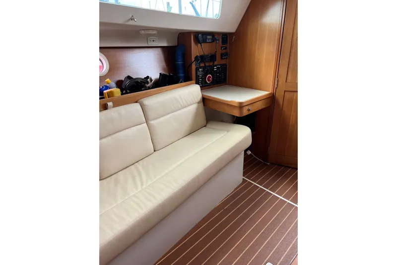 Slide: The Image of Interior of 2007 Catalina 309 sailboat with beige seating and wooden cabinetry. - 21