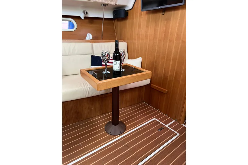 Slide: The Image of Luxurious interior of 2007 Catalina 309 yacht with wine setup on wooden table. - 24
