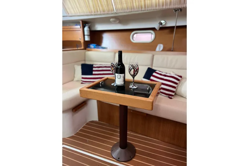 Slide: The Image of Interior of 2007 Catalina 309 yacht with wine and glasses on table. - 25