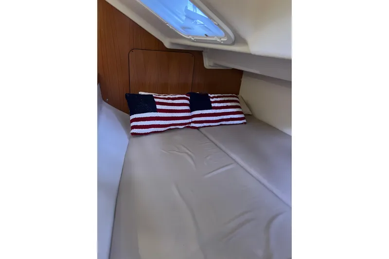 Slide: The Image of Cozy cabin interior of 2007 Catalina 309 sailboat with American flag pillows. - 28
