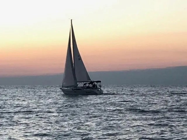 Slide: The Image of Sailboat Catalina 309, 2007 model, cruising at sunset on calm ocean waters. - 3