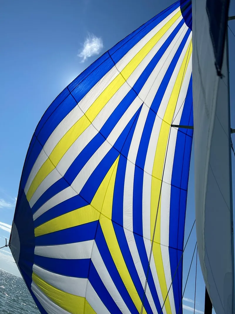 Slide: The Image of Colorful sail of a 2007 Catalina 309 yacht against a clear blue sky. - 7