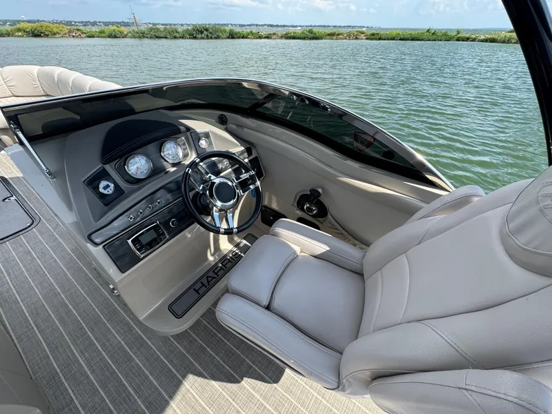 Slide: The Image of Steering console of 2016 Harris Solstice DC 250 boat with water view. - 12