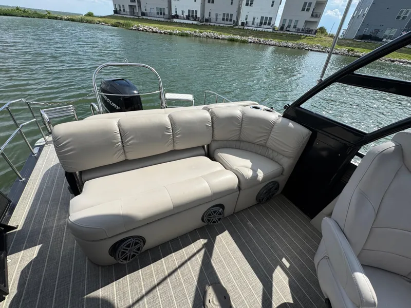 Slide: The Image of Luxurious seating on 2016 Harris Solstice DC 250 boat, with scenic waterfront view. - 16