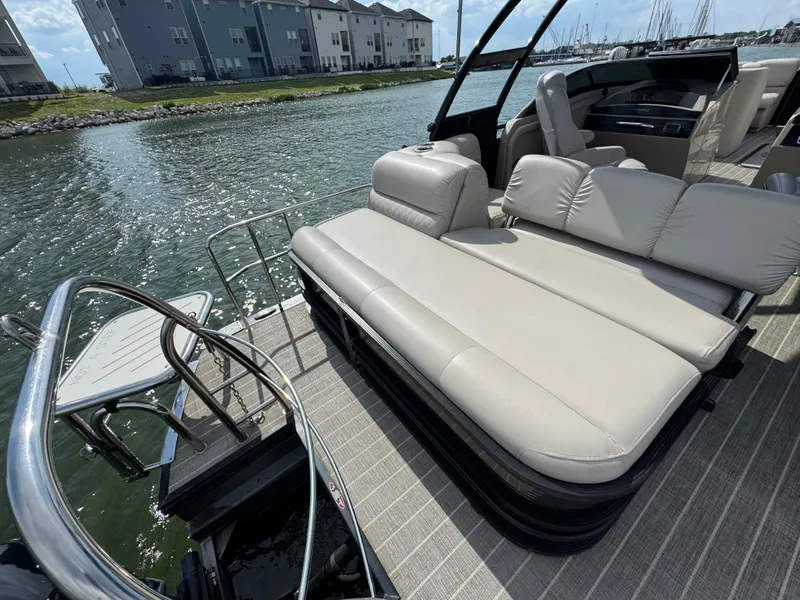 Slide: The Image of Luxury seating on 2016 Harris Solstice DC 250 boat, docked by waterfront homes. - 18