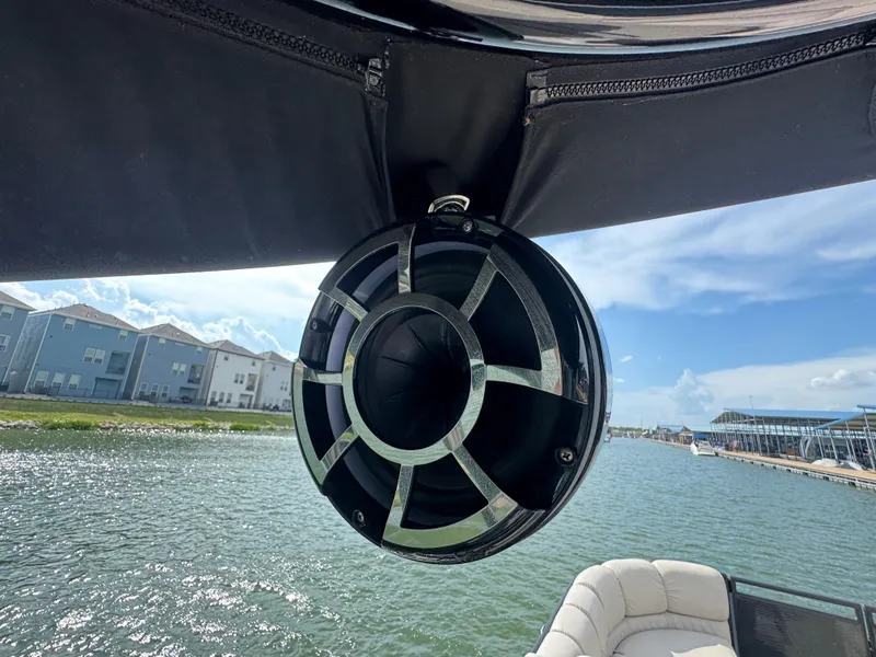 Slide: The Image of Speaker on a 2016 Harris Solstice DC 250 boat, with waterfront view. - 22