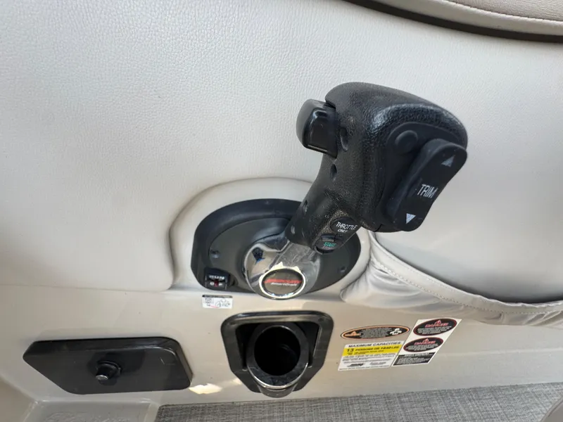 Slide: The Image of Throttle control of a 2016 Harris Solstice DC 250 boat, featuring trim adjustment buttons. - 24