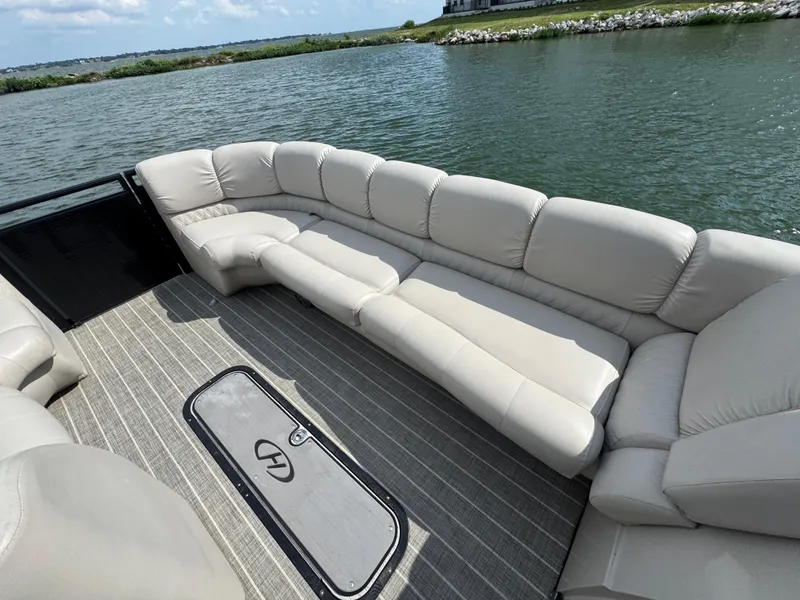 Slide: The Image of Luxurious seating on 2016 Harris Solstice DC 250 pontoon boat by a serene lake. - 7