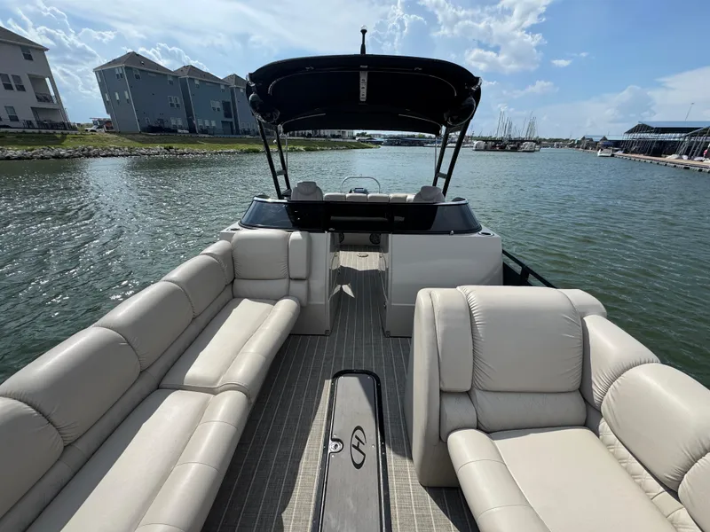 Slide: The Image of 2016 Harris Solstice DC 250 pontoon boat with spacious seating on a sunny day. - 9