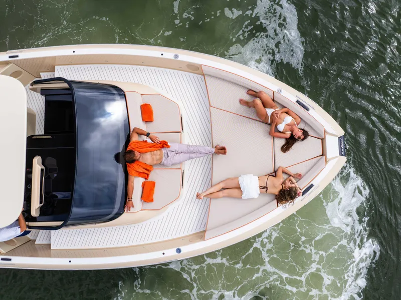 Slide: The Image of 2026 Bellini Astor 36 yacht with people sunbathing on deck, cruising on water. - 15