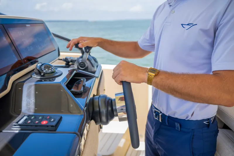 Slide: The Image of Person steering a 2026 Bellini Astor 36 yacht, showcasing modern controls and navigation. - 8