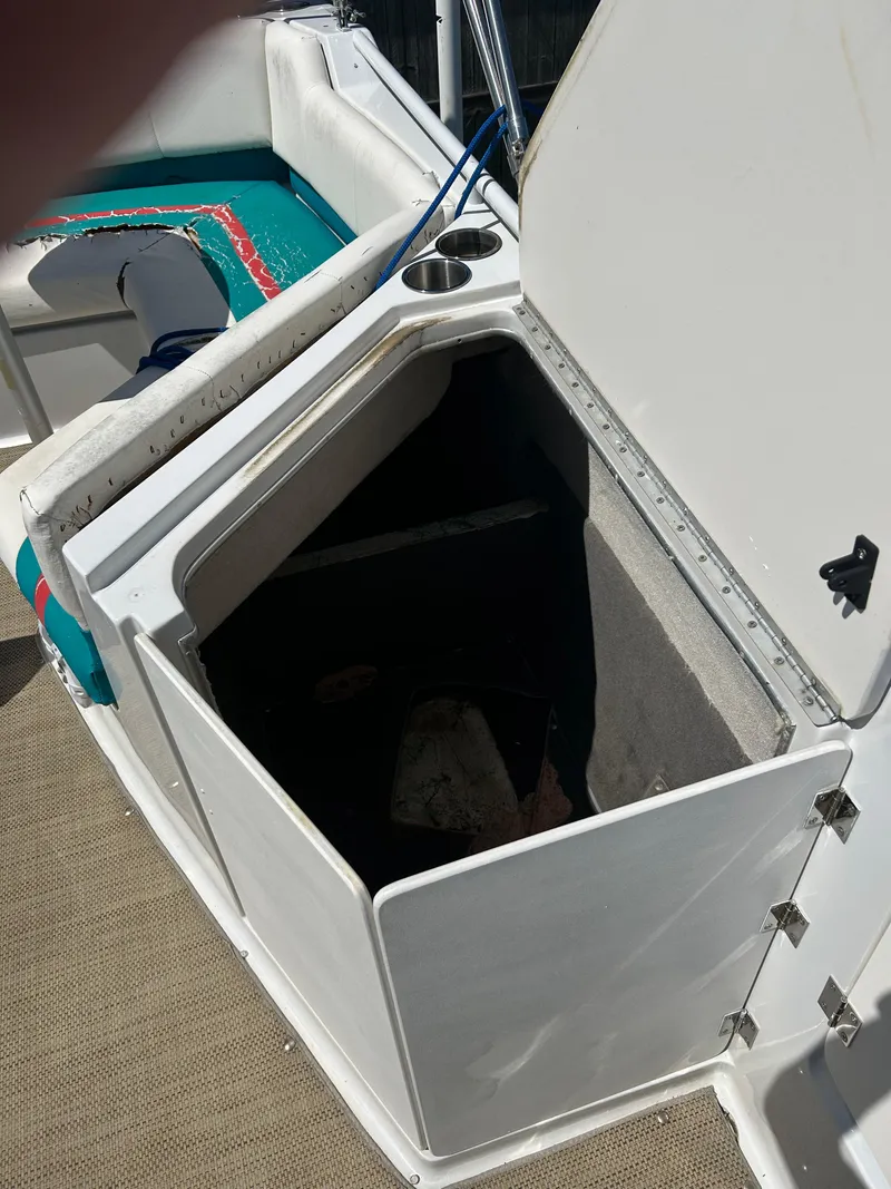 Slide: The Image of Open storage compartment on 1998 Bayliner Rendevous 26 boat with seating area. - 11
