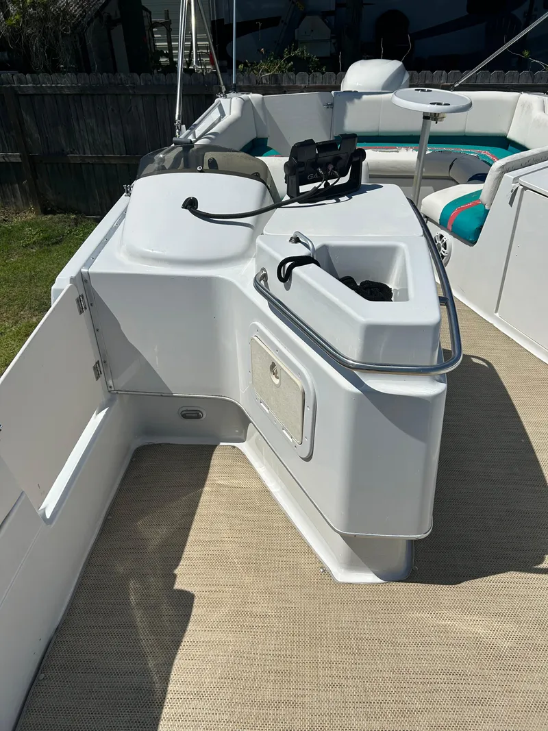 Slide: The Image of 1998 Bayliner Rendevous 26 boat interior with seating and storage compartments. - 12