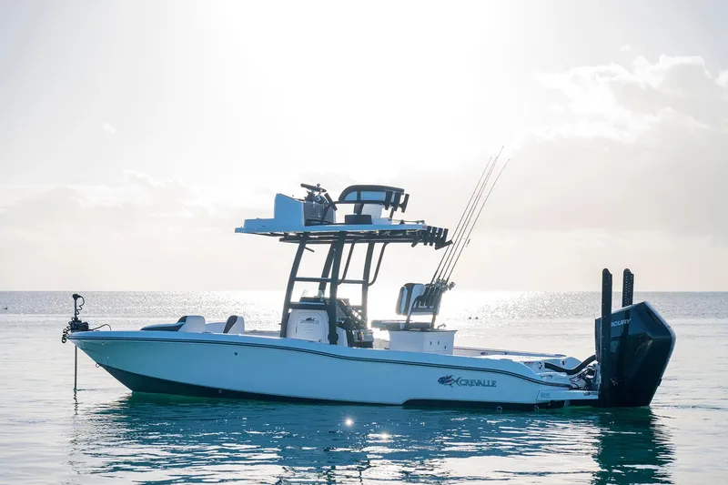 The Image of 2026 Crevalle 26 HCO boat on trailer, parked beside a building. - 0