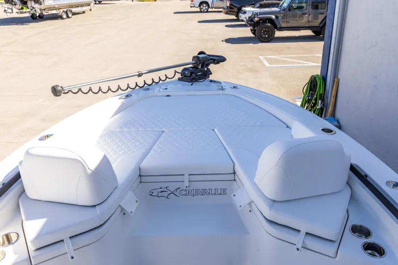 Slide: The Image of 2026 Crevalle 26 HCO boat with cushioned seating and trolling motor on deck. - 13