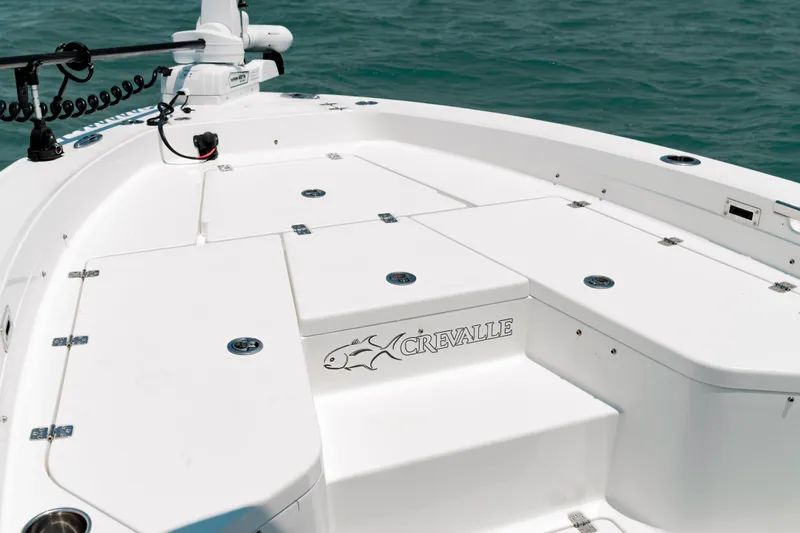 Slide: The Image of 2026 Crevalle 26 HCO boat with white seating and trolling motor on deck. - 3