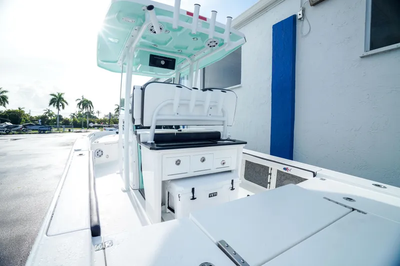 Slide: The Image of 2026 Crevalle 26 HCO boat with white cushioned seating and Mercury outboard engine. - 5