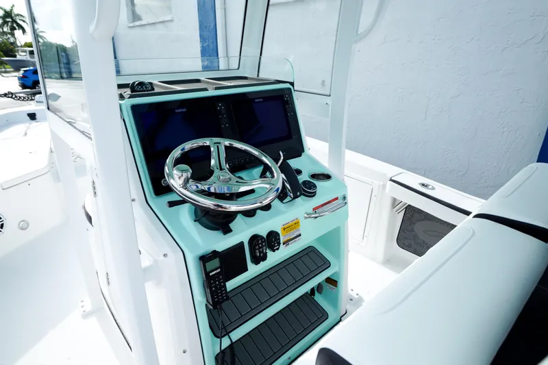 Slide: The Image of 2026 Crevalle 26 HCO boat interior with seating, rod holders, and storage. - 6