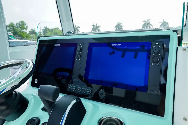 Slide: The Image of 2026 Crevalle 26 HCO boat on trailer, parked outside a building under a clear sky. - 8