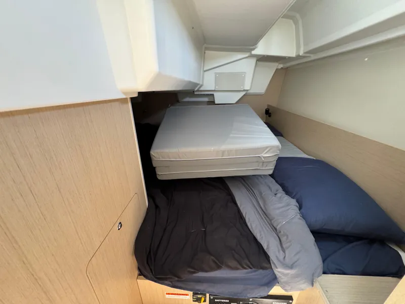 Slide: The Image of Interior cabin of 2021 Beneteau Oceanis 35.1 yacht with bedding and storage. - 17