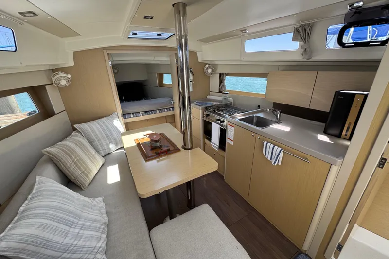Slide: The Image of Interior of 2021 Beneteau Oceanis 35.1 yacht with kitchen and seating area. - 23