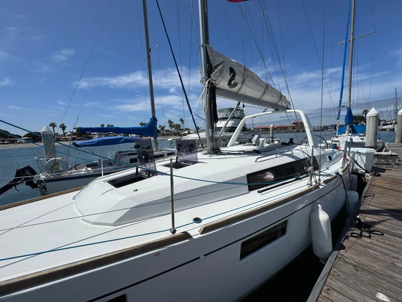 Slide: The Image of 2021 Beneteau Oceanis 35.1 sailboat docked at marina under clear blue sky. - 5