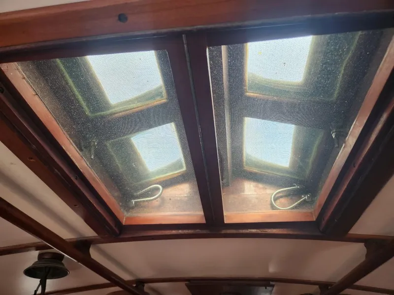 Slide: The Image of Wooden interior ceiling of a 1976 Tayana 37 sailboat with skylights. - 14