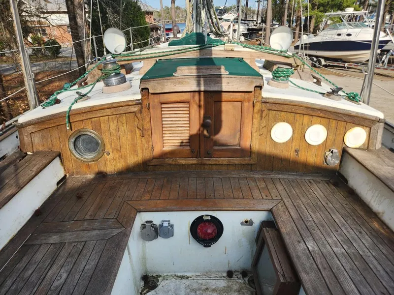 Slide: The Image of 1976 Tayana 37 sailboat deck with wooden finish and nautical equipment. - 19