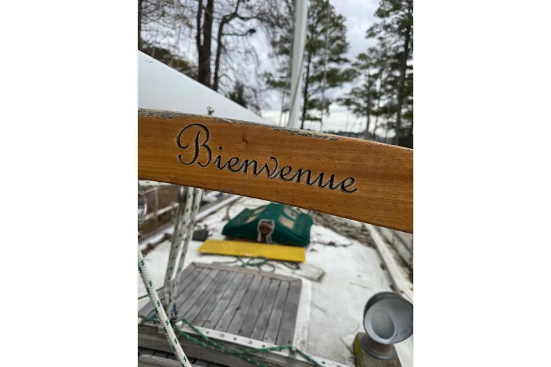 Slide: The Image of Wooden deck of 1976 Tayana 37 sailboat with "Bienvenue" inscription. - 40