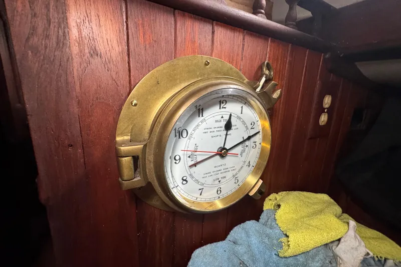 Slide: The Image of Brass ship's clock on 1976 Tayana 37 wooden interior wall. - 47