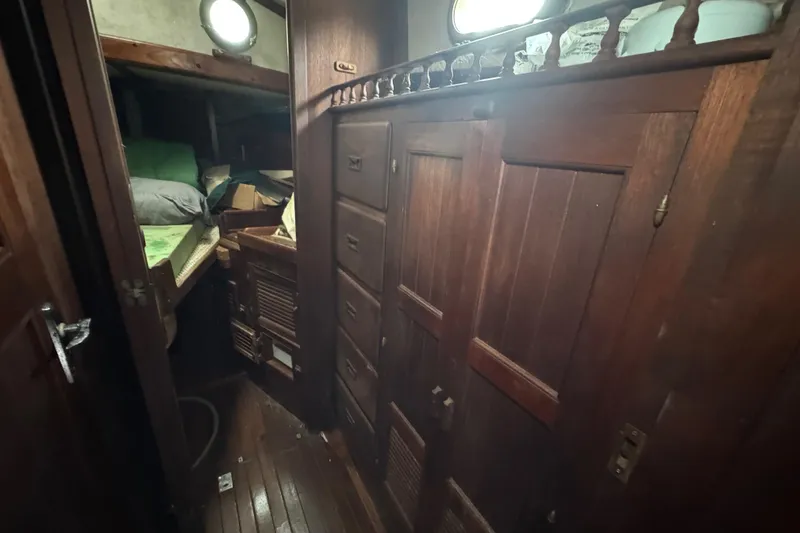 Slide: The Image of 1976 Tayana 37 sailboat interior with wooden cabinetry and cozy sleeping area. - 49
