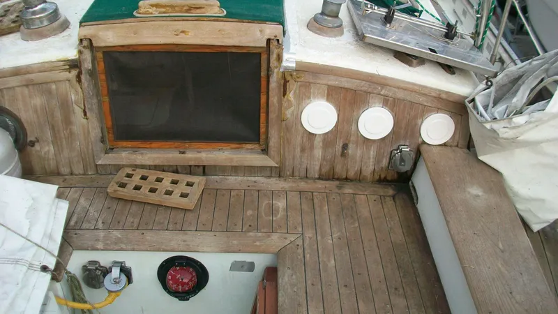 Slide: The Image of 1976 Tayana 37 sailboat cockpit with wooden deck and hatch. - 5
