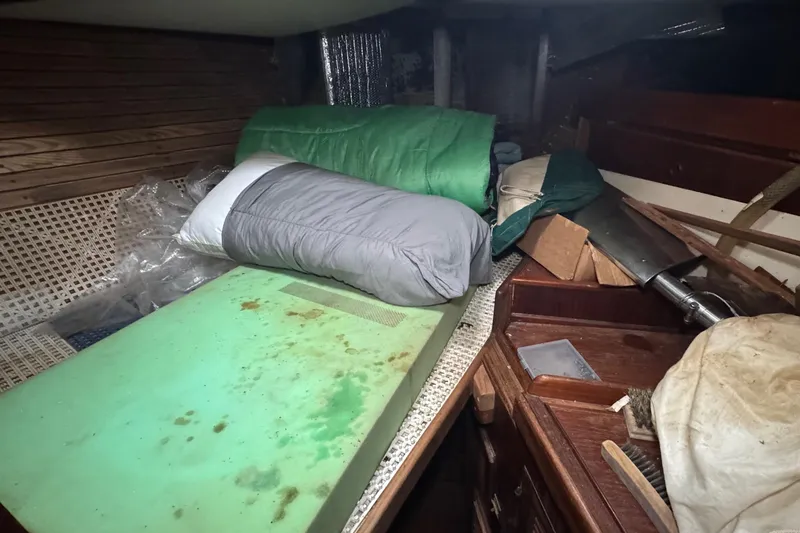 Slide: The Image of Interior of a 1976 Tayana 37 sailboat with bedding and storage items. - 50