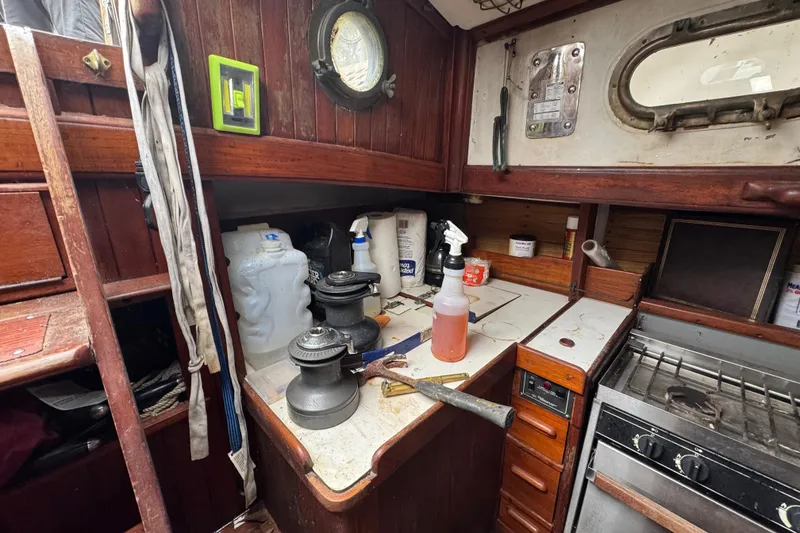 Slide: The Image of Interior of a 1976 Tayana 37 sailboat with wooden cabinetry and nautical equipment. - 54