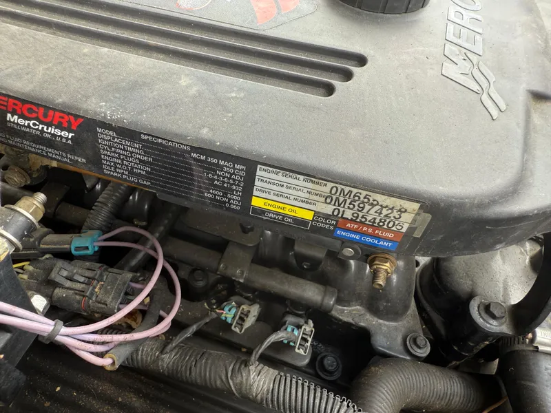 Slide: The Image of Close-up of a 2004 Sea Ray 220 Select engine, showing Mercury MerCruiser specifications. - 11