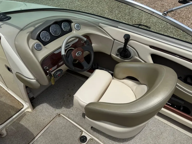 Slide: The Image of 2004 Sea Ray 220 Select boat interior with steering wheel and dashboard controls. - 19