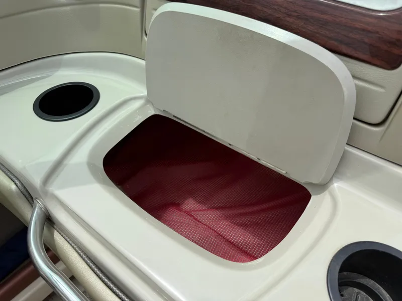 Slide: The Image of Open storage compartment on 2004 Sea Ray 220 Select boat with cup holders. - 8