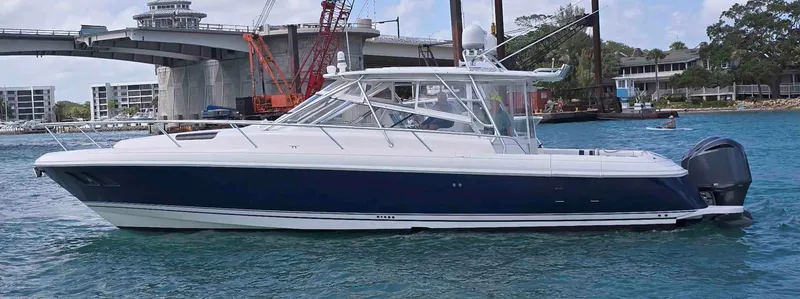 The Image of 2008 Intrepid 430 Sport Yacht on water near a bridge and construction site. - 0