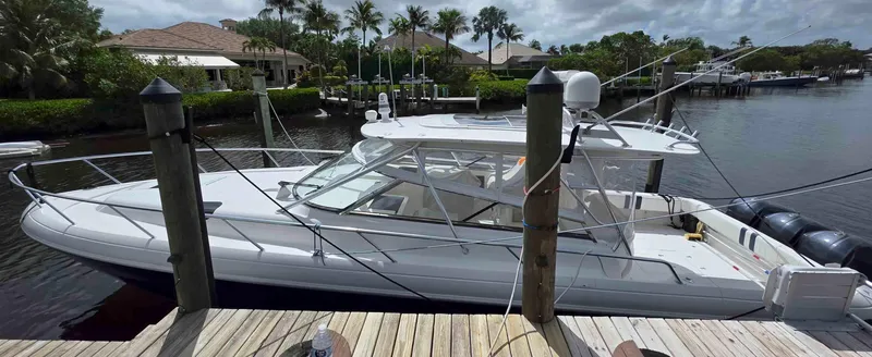 Slide: The Image of 2008 Intrepid 430 Sport Yacht docked in a scenic marina setting. - 1