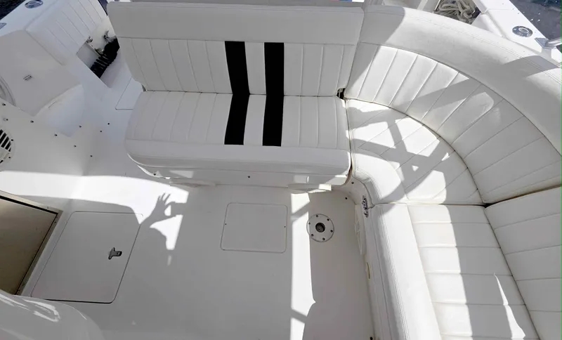 Slide: The Image of 2008 Intrepid 430 Sport Yacht interior with white seating and black accents. - 10