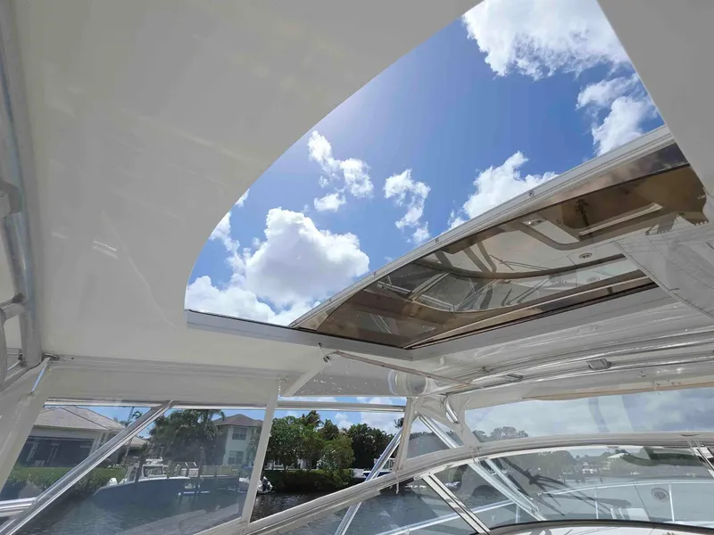 Slide: The Image of Intrepid 430 Sport Yacht 2008 with open sunroof, showcasing clear blue sky and clouds. - 12
