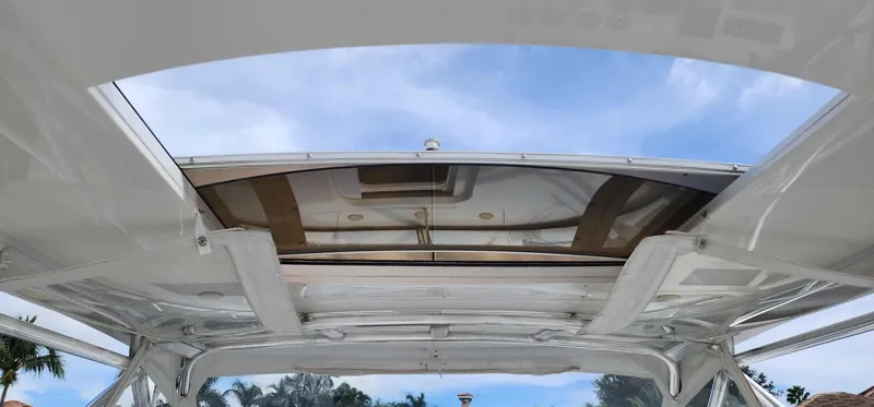 Slide: The Image of 2008 Intrepid 430 Sport Yacht with open sunroof, showcasing clear blue sky. - 13