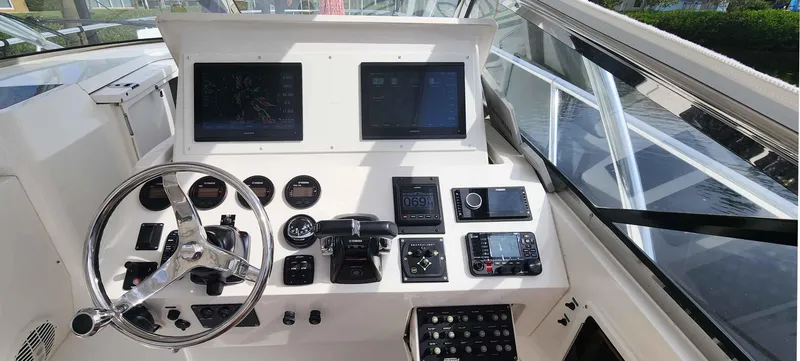 Slide: The Image of Helm of 2008 Intrepid 430 Sport Yacht with dual screens and navigation controls. - 15