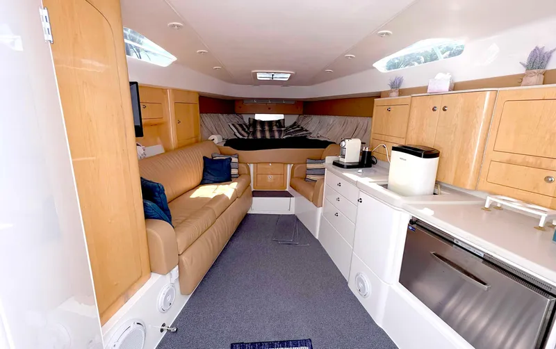 Slide: The Image of Interior of 2008 Intrepid 430 Sport Yacht with modern kitchen and cozy seating area. - 26