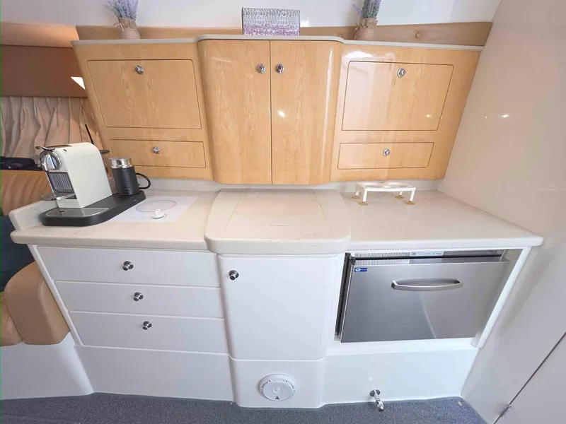 Slide: The Image of 2008 Intrepid 430 Sport Yacht interior kitchen with wooden cabinets and modern appliances. - 31