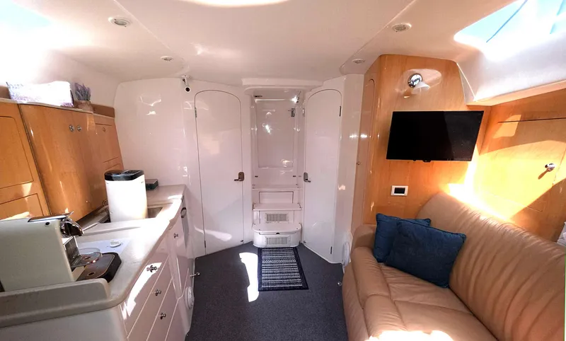 Slide: The Image of Interior of 2008 Intrepid 430 Sport Yacht with kitchenette, sofa, and TV. - 37