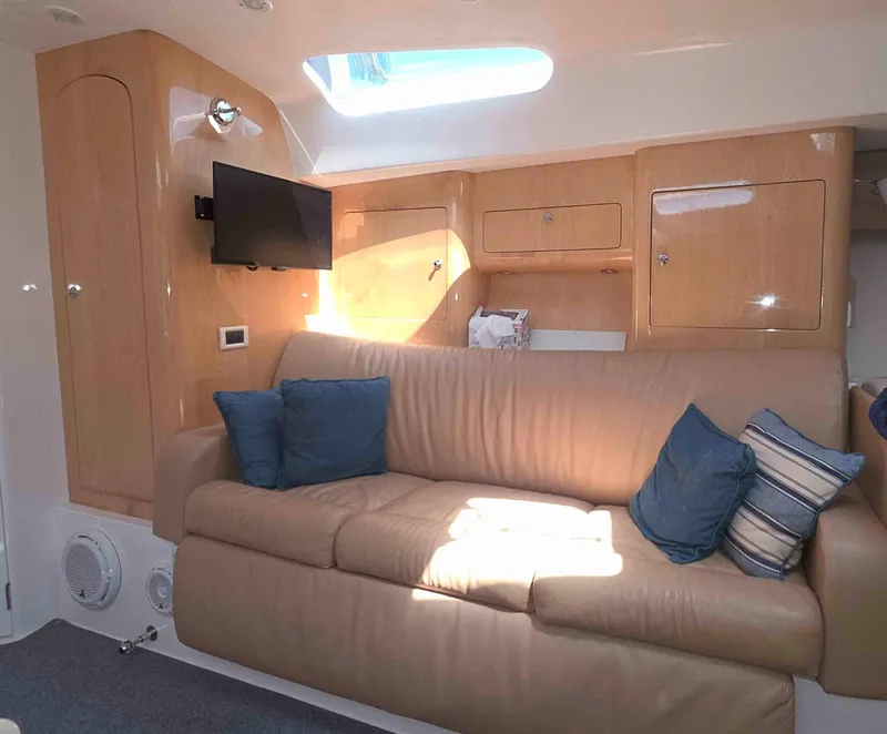 Slide: The Image of Luxurious interior of 2008 Intrepid 430 Sport Yacht with beige sofa and blue cushions. - 38